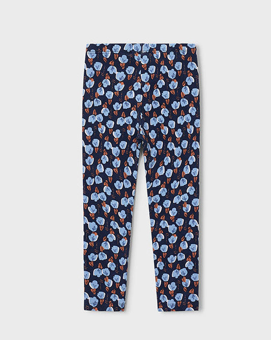 A pair of children's leggings with an all-over repeating pattern of light blue flowers with orange centers on a dark navy background, shown flat against a light gray background.