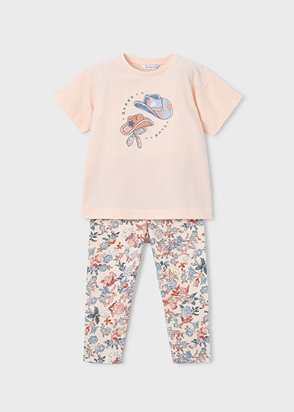 Children's outfit with a pink t-shirt and floral leggings on a white background