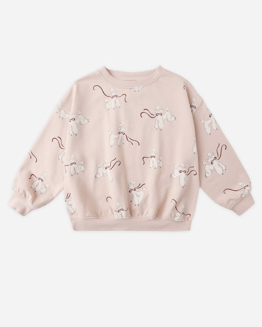Pink sweatshirt with white poodle patterns on a white background.