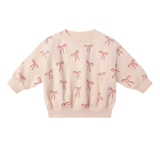 Pink sweatshirt with bow pattern on a pink background