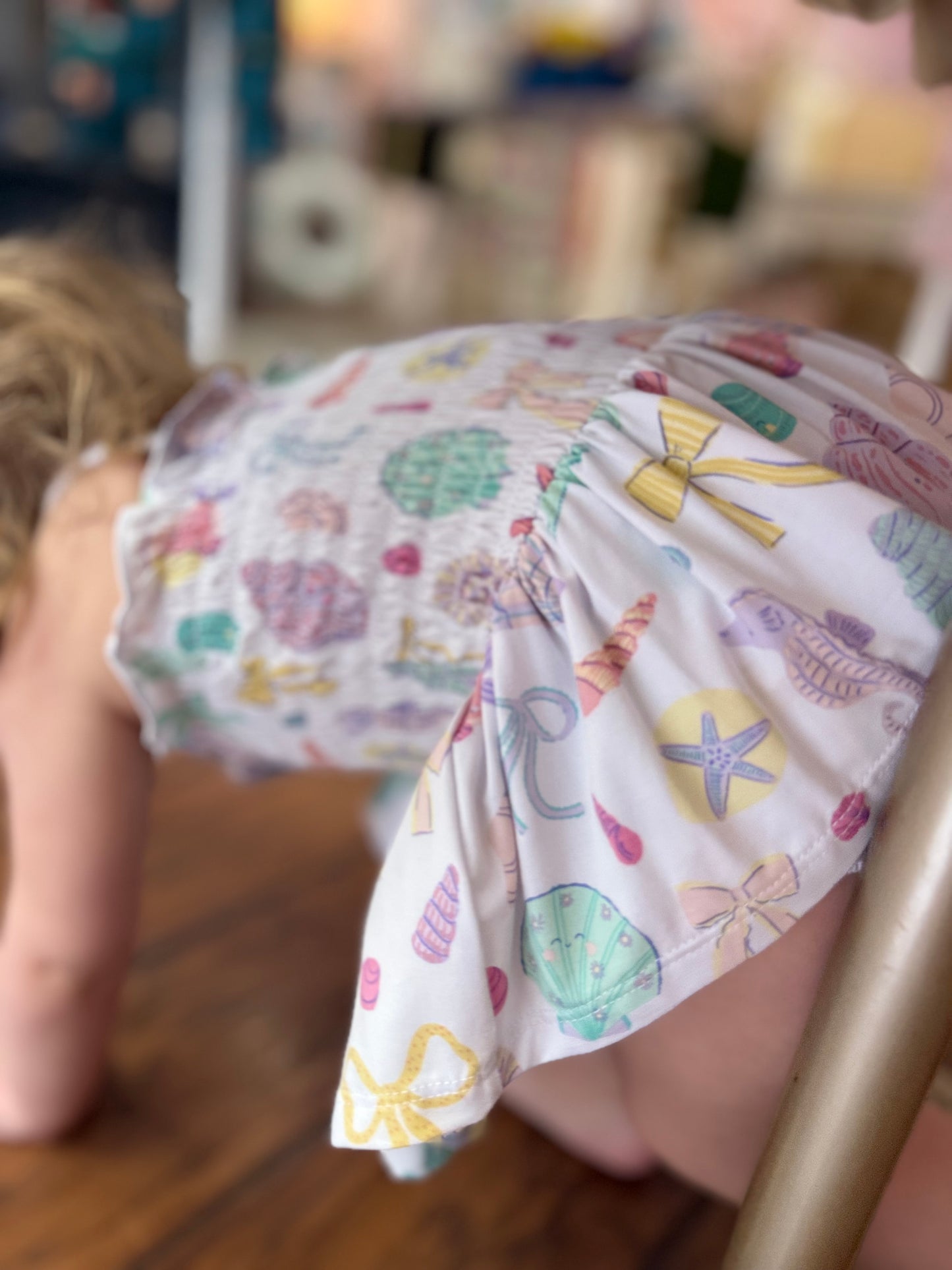 Child wearing colorful patterned shorts with a blurred background