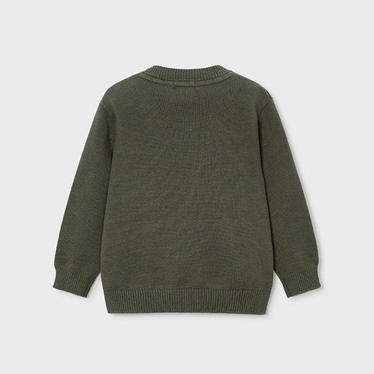 Green sweater on a light gray background