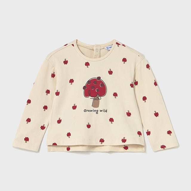 Beige long-sleeve shirt with red apple pattern and 'Growing wild' text on a white background
