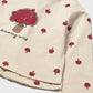 Beige long-sleeve shirt with red tree and leaf pattern on a white background