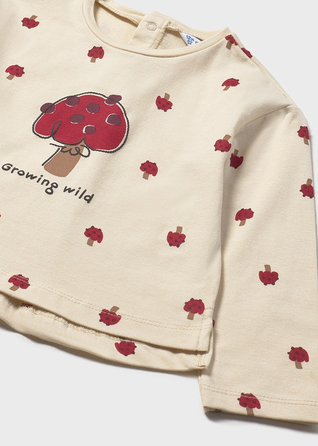 Beige long-sleeve shirt with red tree and leaf pattern on a white background