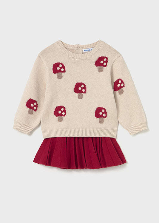Beige sweater with mushroom pattern and red skirt on a white background