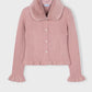 Pink ribbed sweater with a faux fur collar on a light gray background