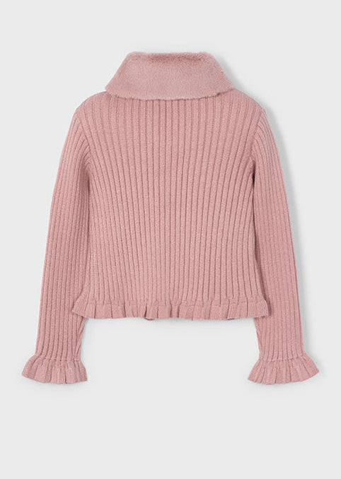 Pink ribbed sweater on a light gray background