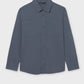 Blue button-up shirt on a light gray background