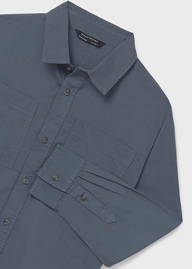 Blue shirt with button details on a light gray background