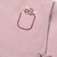 Pink t-shirt with floral pocket design on a white background