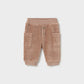 Brown baby pants with button details on a light gray background