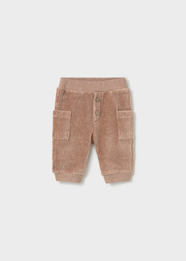 Brown baby pants with button details on a light gray background