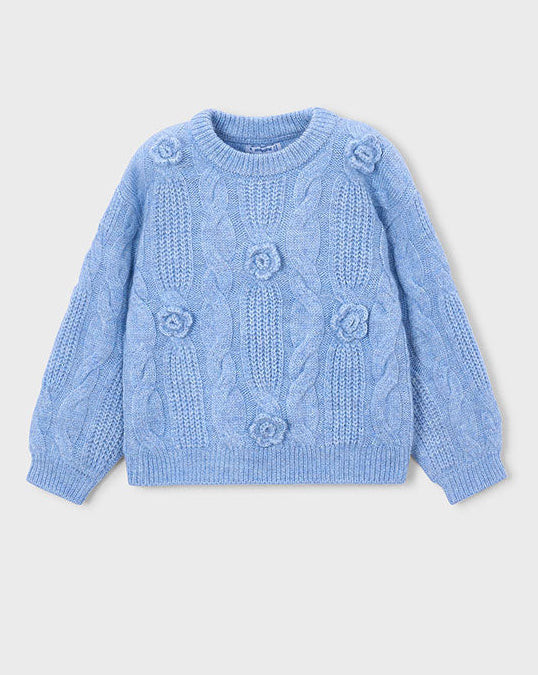 Blue knitted sweater with floral patterns on a light gray background