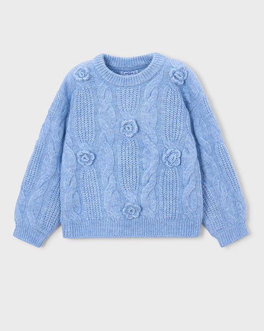 Blue knitted sweater with floral patterns on a light gray background