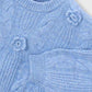 Close-up of a blue knitted sweater with floral patterns on a white background