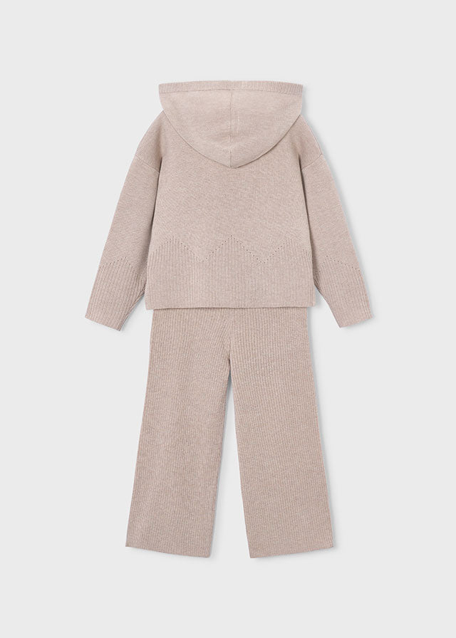 A two-piece children's knit loungewear set in a light beige color, featuring a hooded sweatshirt and matching wide-leg pants, shown from the back on a light gray background.