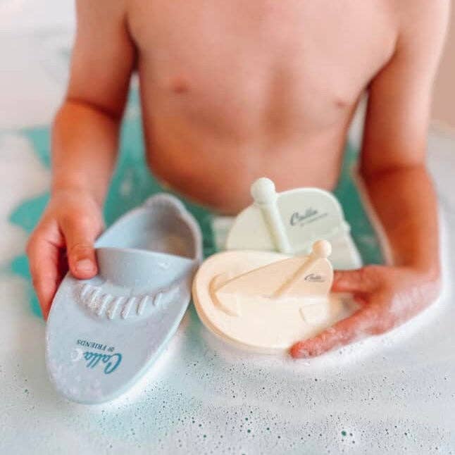 Child playing with bath toys in a bathtub