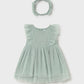 Light green baby dress with ruffled sleeves and matching headband on a light gray background