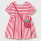 Coral pink and white striped dress with a matching strawberry bag on a light gray background