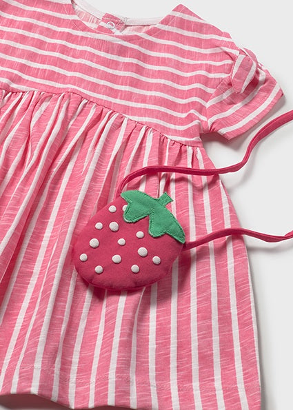 Pink and white striped dress with a strawberry-shaped purse on a white background