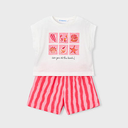 Children's outfit with a white top with pink ocean graphics and pink striped shorts on a white background