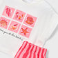 White shirt with pink shell and starfish designs and red striped pants on a white background