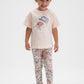 Child wearing a light pink t-shirt with a design and floral leggings on a white background