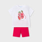 White t-shirt with red sneakers graphic and pink shorts on a white background