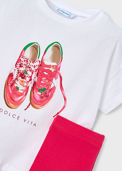 White t-shirt with red sneakers graphic, pink pants, and 'Dolce Vita' branding on a white background.