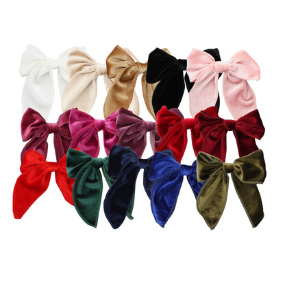 Set of colorful velvet hair bows on a white background