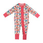 A baby long-sleeve footless one-piece jumpsuit with a colorful bird and snake pattern on a cream background, featuring bright pink ruffle trim down the front and matching pink cuffs and collar.