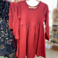 Red dress on a hanger with a blurred store background