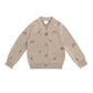 Beige sweater cardigan with acorn patterns on a white background