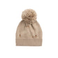 Beige knit sweater beanie with acorns a pom-pom on a white background