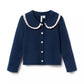Navy blue cardigan with white trim on a white background