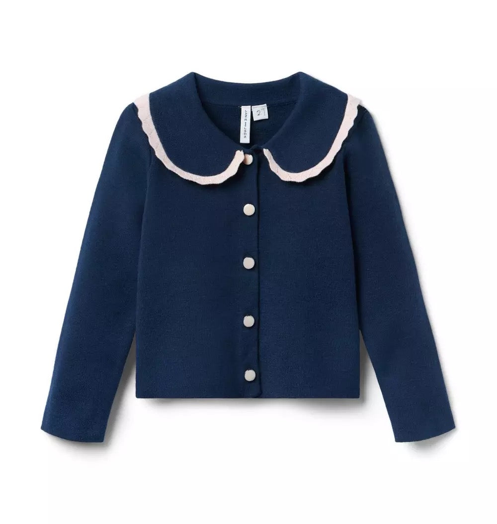 Navy blue cardigan with white trim on a white background