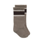Pair of brown socks with a black stripe on a white background
