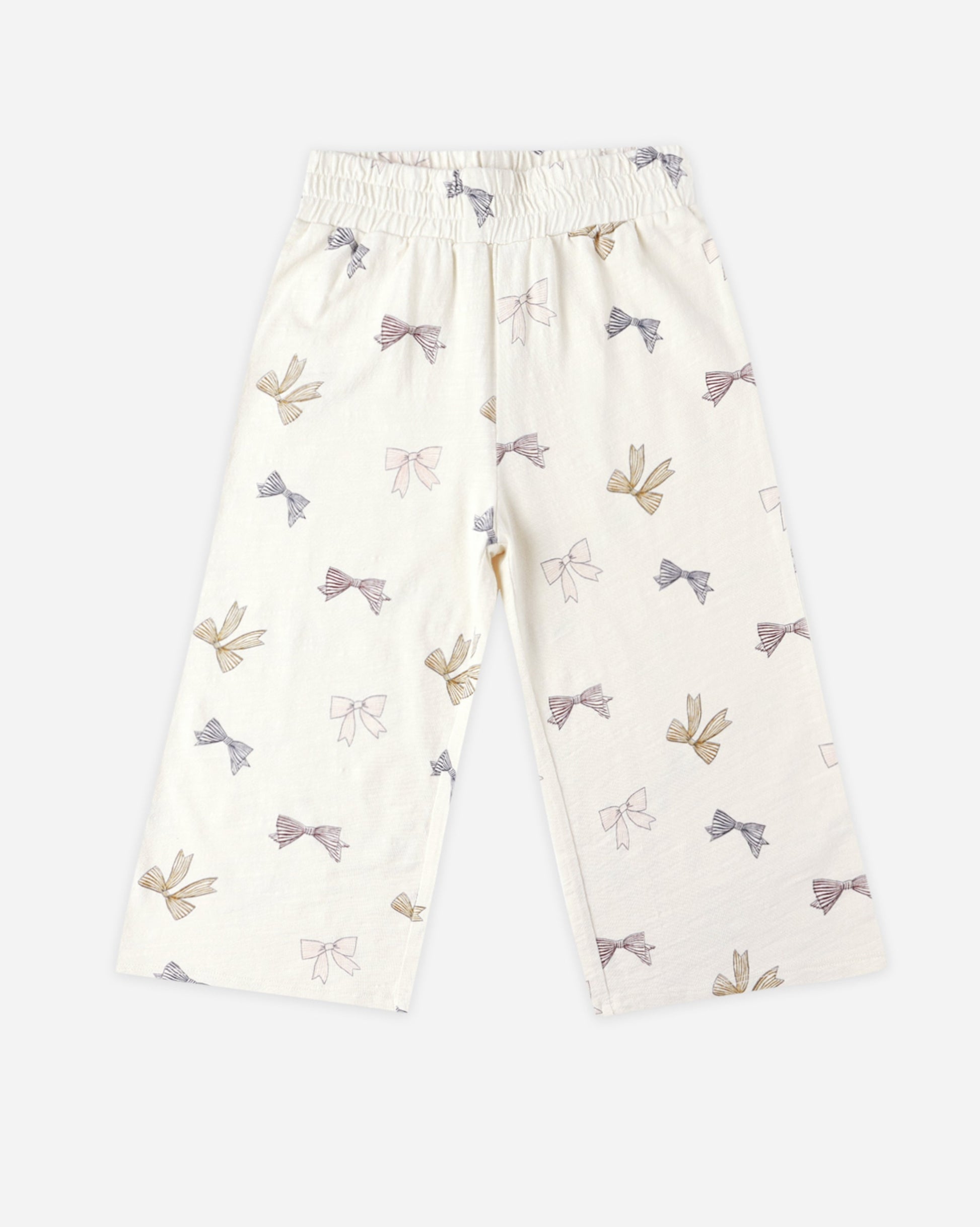 Natural tone wide leg pants with bow pattern on a white background
