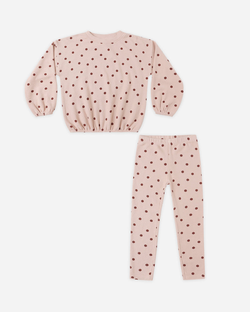 Pink polka dot outfit with long-sleeve top and pants on a white background