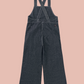 Dark denim overalls on a white background