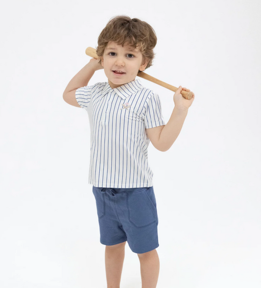 Child wearing a striped shirt and shorts holding a baseball bat on a white background