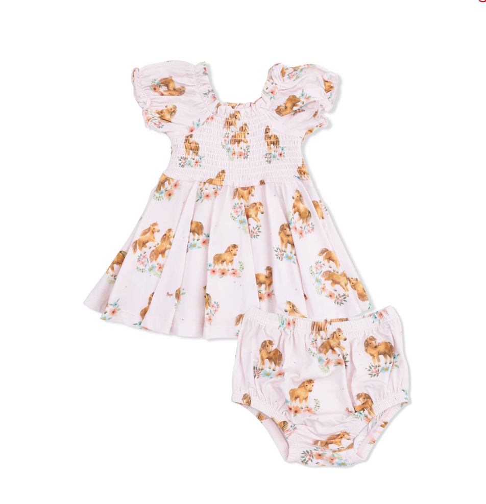 Baby dress and romper set with dog print on a white background