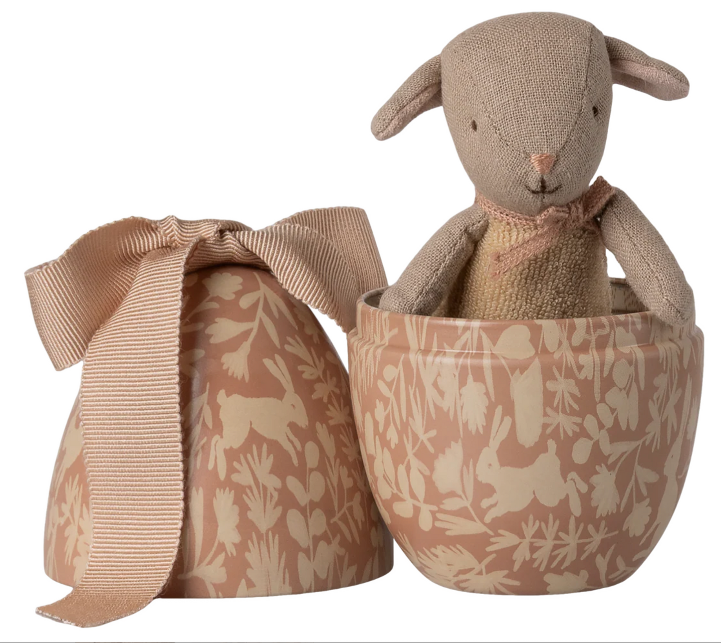 Textured lamb toy in a patterned container with a matching bow on a white background