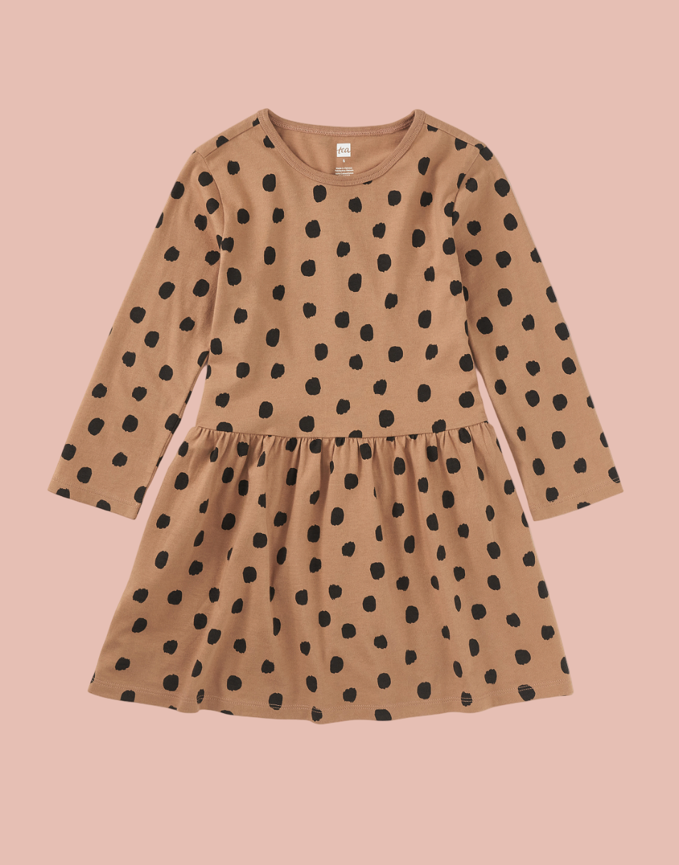 Brown dress with black polka dots on a white background