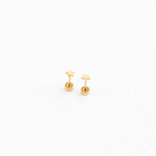 Gold star earrings on a white background