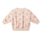 Pink sweatshirt with bow pattern on a pink background