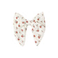 Floral-patterned bow on a white background