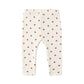 White baby leggings with red heart pattern on a white background